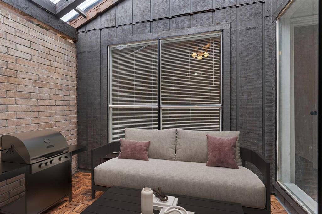 A unique architectural feature, this enclosed atrium offers an ideal space for relaxing or enjoying container gardening with tons of natural light.