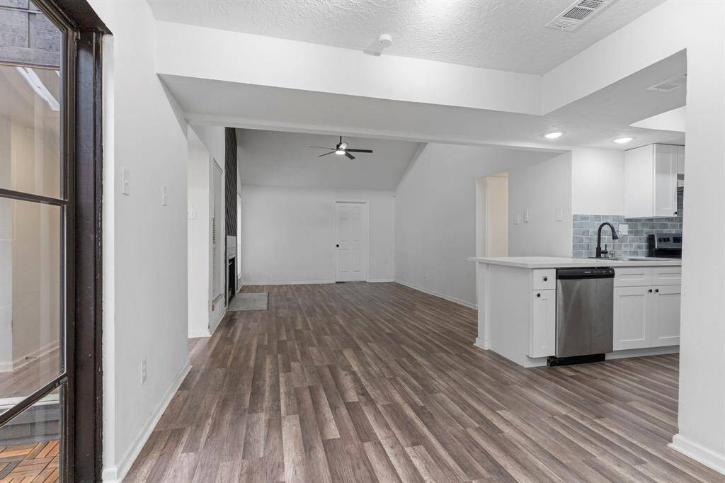 Step inside to soaring ceilings and beautiful luxury vinyl plank flooring. The open layout connects seamlessly to the kitchen and outdoor space for effortless living.