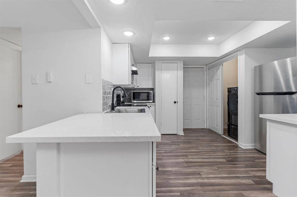 Stunning updated gourmet kitchen features chic modern kitchen boasting sleek quartz counters, white shaker cabinetry, subway glass tile backsplash, and more.  Make that call and let me show you this ready to move in one story ranch home to you today!