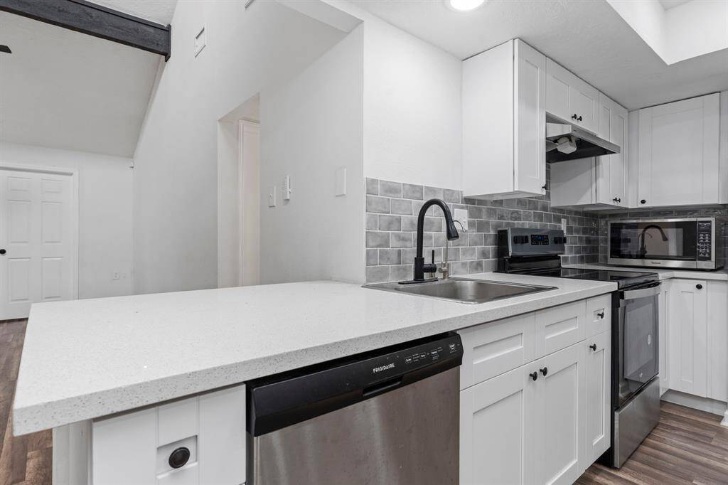 A close up to show how beautiful these quartz counters are!  Deep stainless-steel sink with swan pull out kitchen faucet and more!