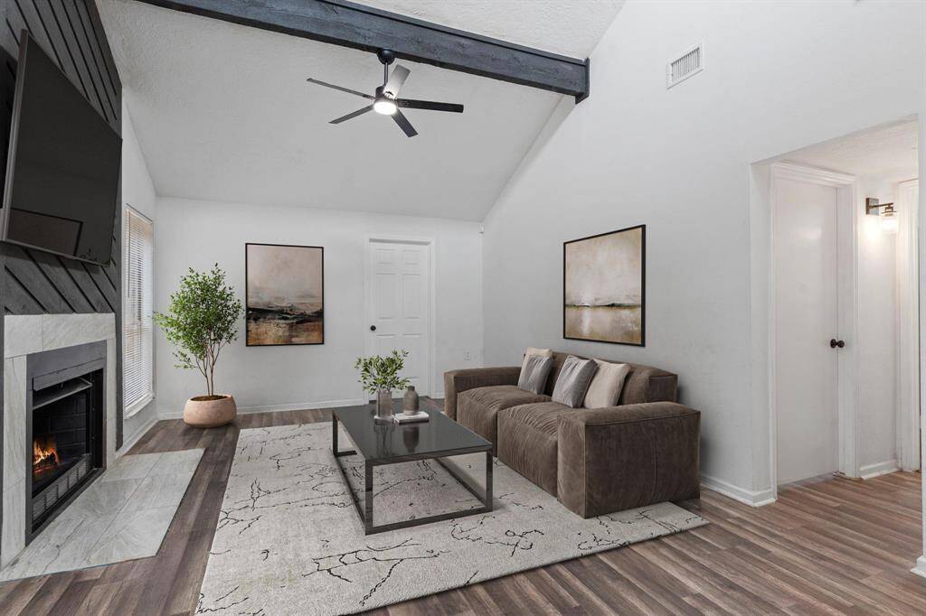 Cozy up in the main family room with a dramatic vaulted ceiling and centerpiece fireplace, offering warmth and style.