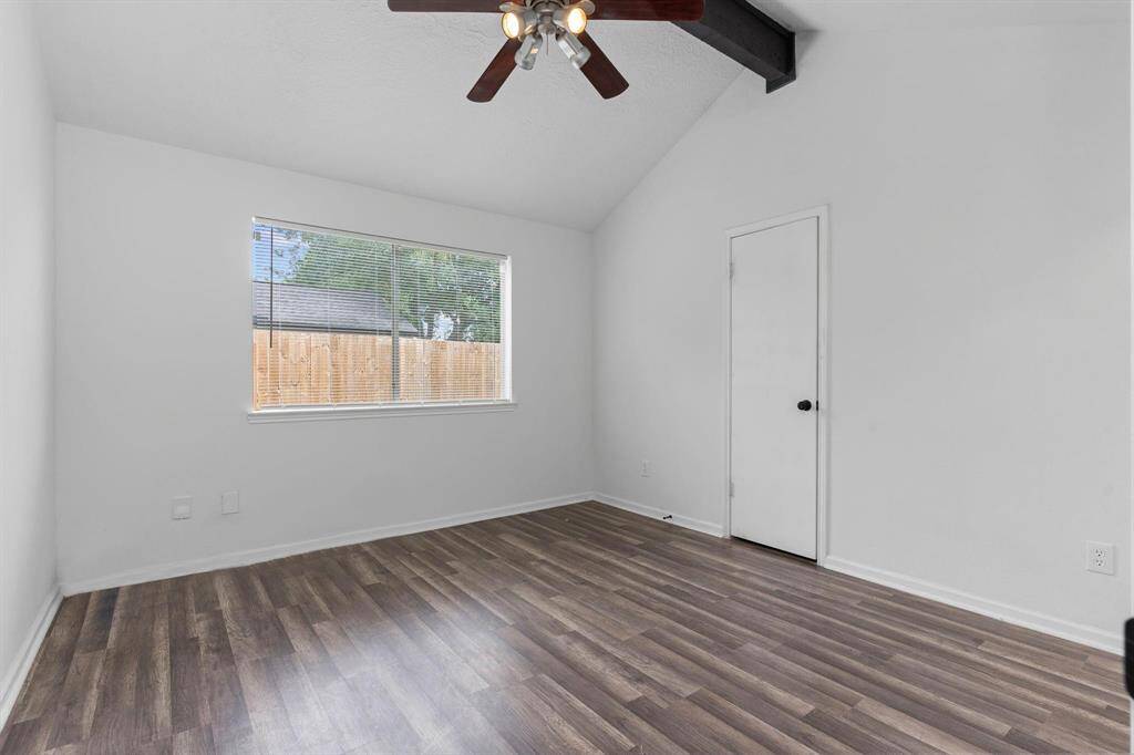 Guest bedroom tucked away with high vaulted ceilings and more.