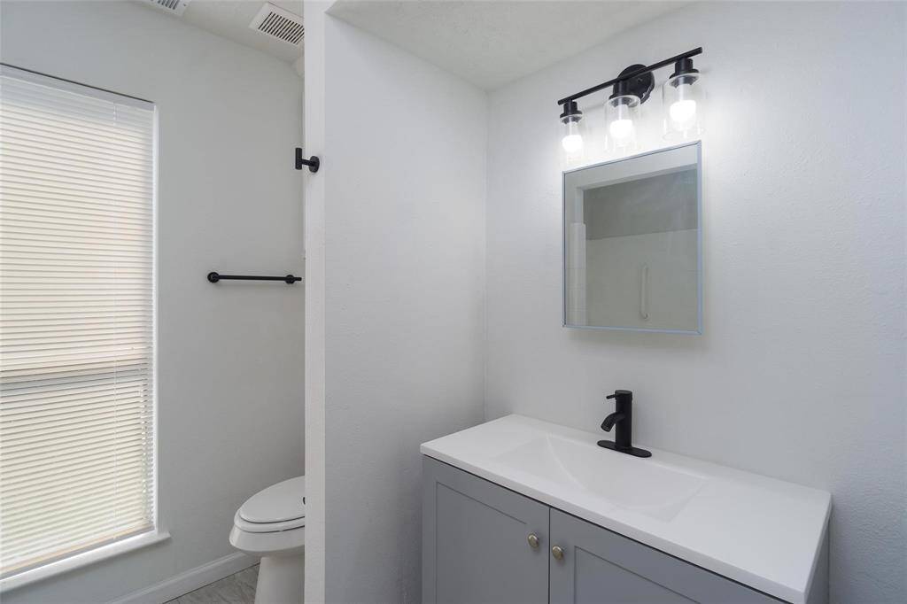 Primary bathroom also has been updated and now offers modern cabinetry, stylish lighting, and plenty of space.  Tub and shower combination.