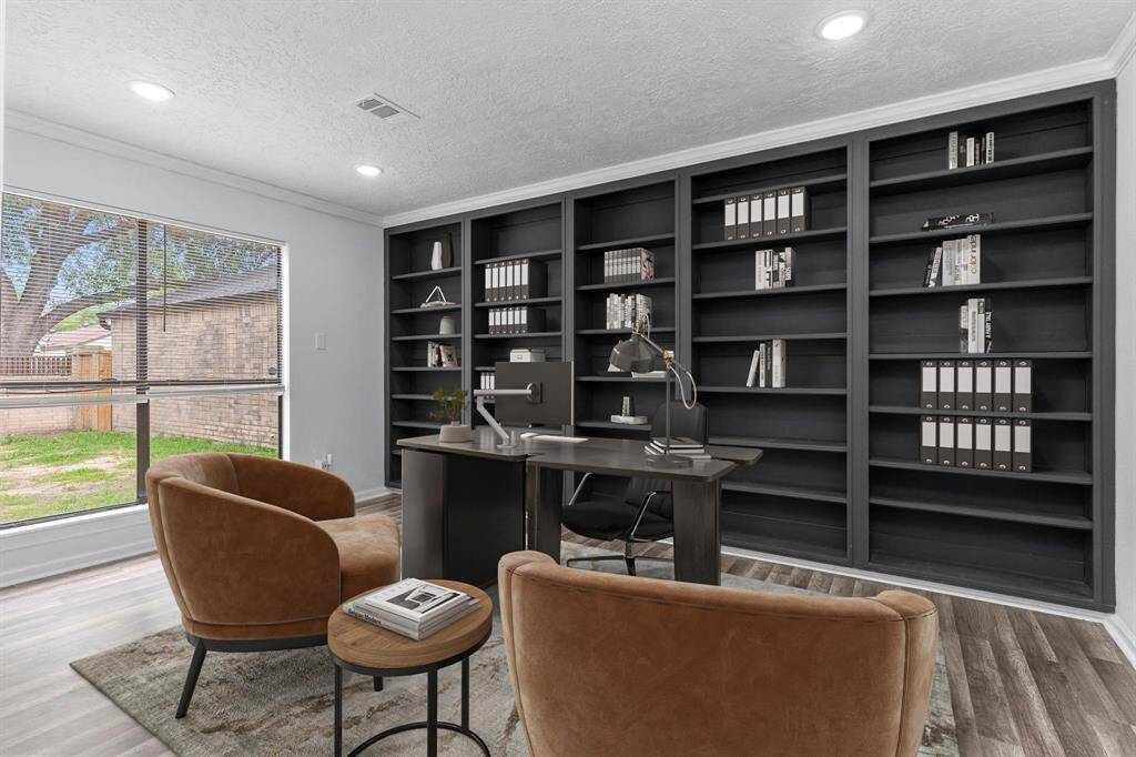 Amazing Guest Bedroom with walk in closet.  Beautiful crown molding, recessed lighting, carefree vinyl wood like plank flooring and custom wall of bookshelves.  This also would be a wonderful home office!