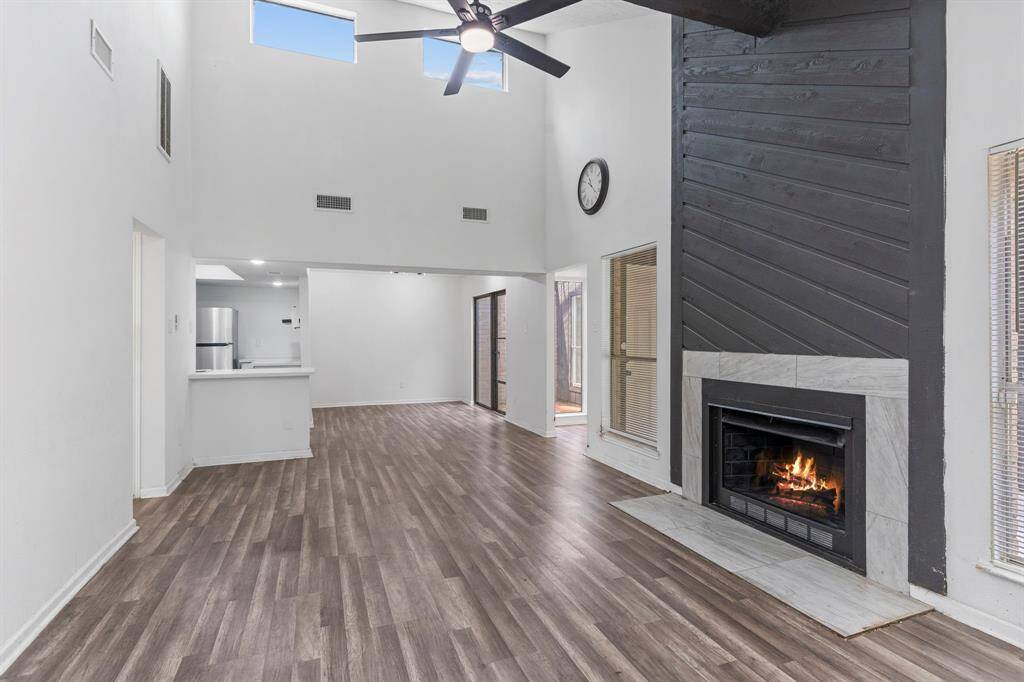 Dramatic large family area with high amazing, two-story wall of windows, vaulted ceilings with wood beam.What a wow factor to this stunning home.