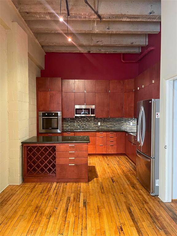 Modern Kitchen with stainless appliances and tall ceilings.
