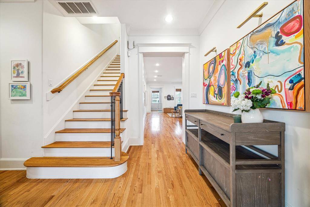 A large stair hall connects the living/dining room to the eat-in kitchen and family room while providing access to the mudroom and powder room.