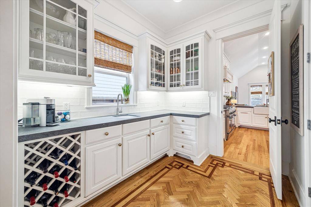 Enjoy easy arrivals and departures in this mudroom featuring bench seating with storage, cubbies, coat hooks and access to the attached garage.