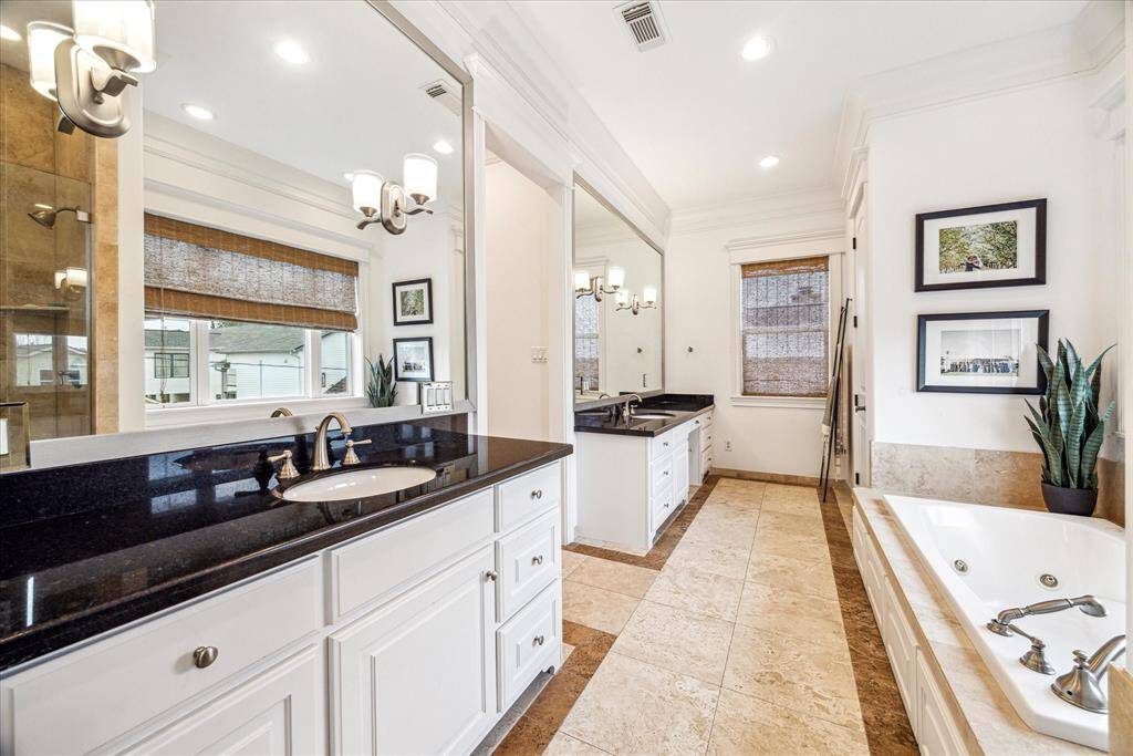 Choose from a relaxing jetted soaking tub or glass rain shower in the primary bath.