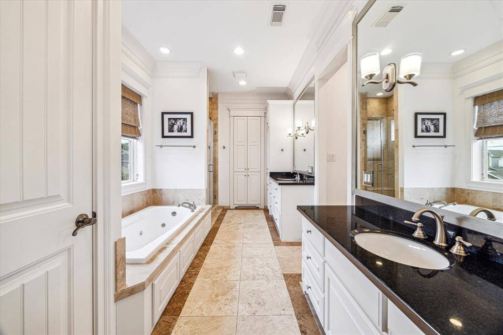 This corner secondary bedroom enjoys a custom closet, double exposures and access to the full hall bathroom.