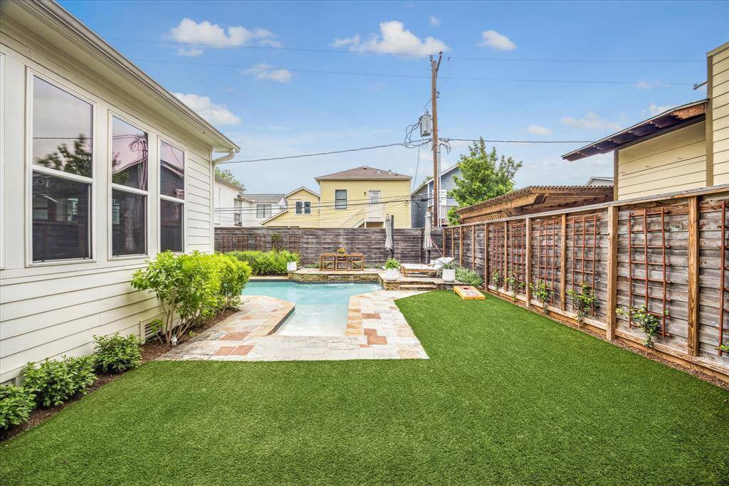 This beautifully planned pool features a beach entry, water feature, tanning shelf and lovely flagstone surround.
