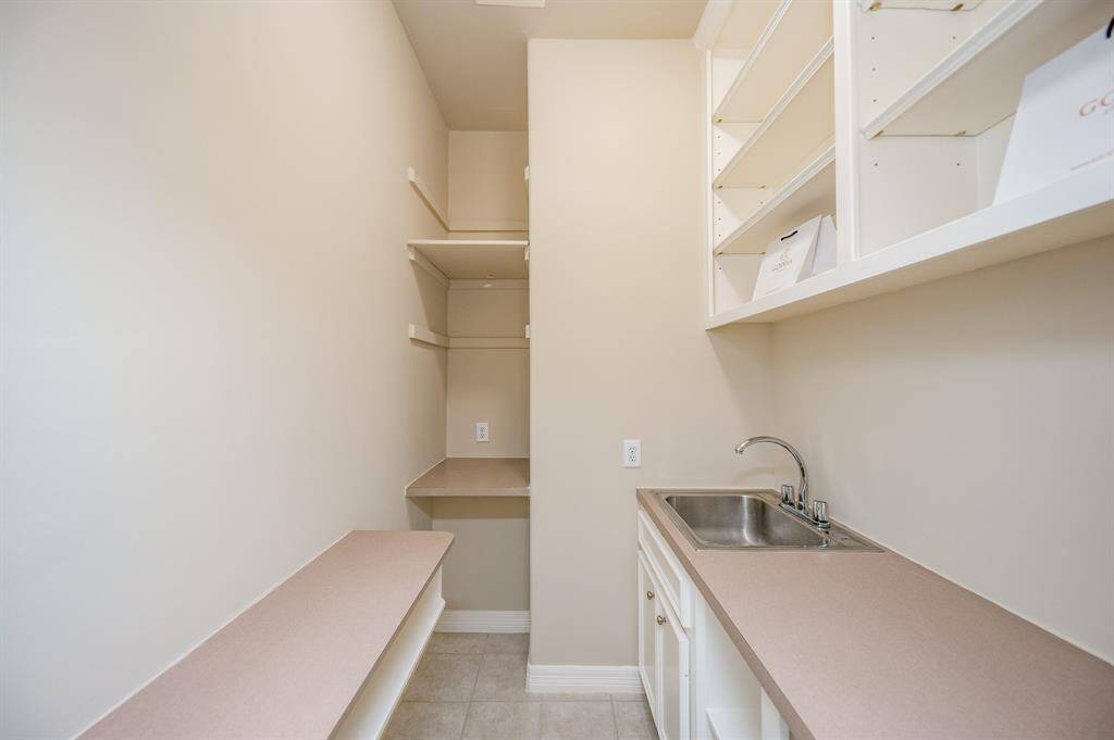 extra storage closet with wet bar serving as wine room