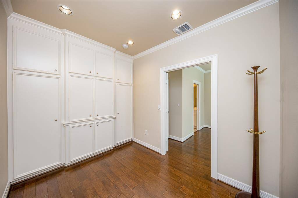 3rd bedroom with wall of cabinets