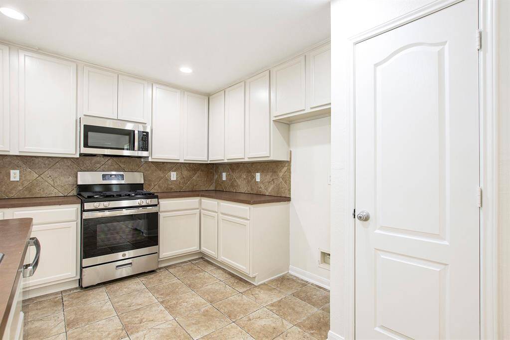 This view highlights the space in the kitchen where your choice of refrigerator would perfectly fit alongside the pantry, offering a functional and well-organized layout.