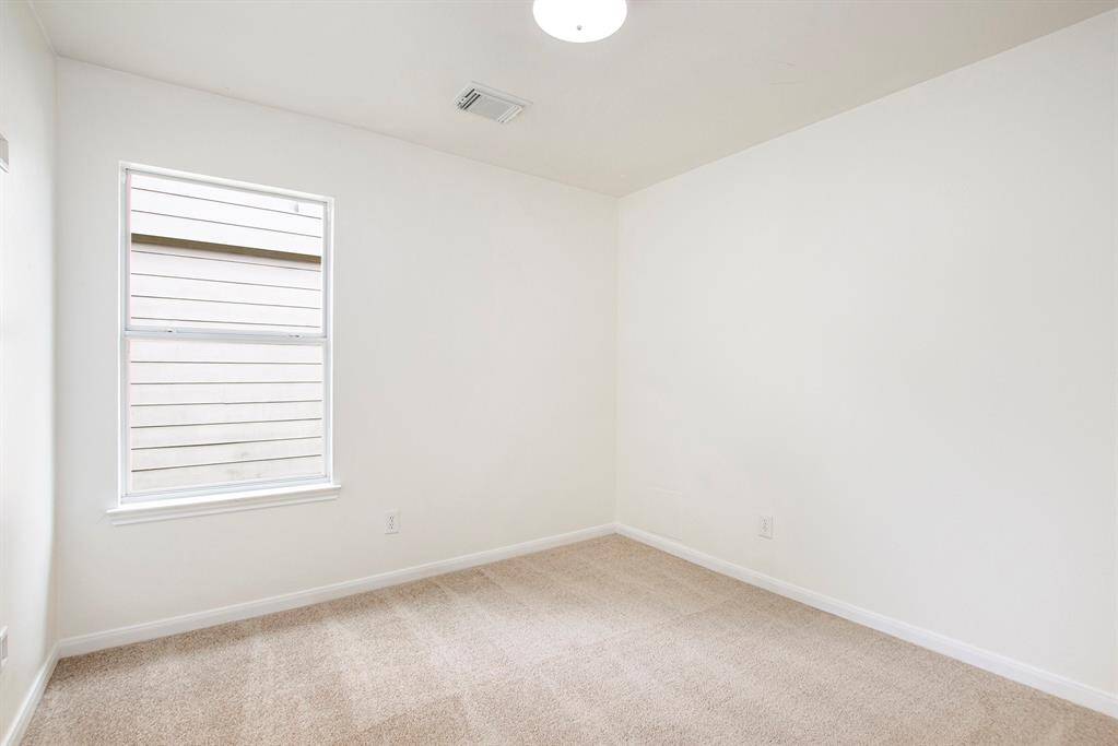 This third bedroom offers a bright and inviting space, with clear, open areas that highlight its generous size and versatility, perfect for creating a cozy retreat or functional room to suit your needs.