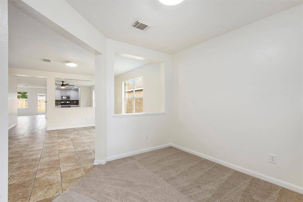 This view captures the seamless flow into the heart of the home, showcasing the open-concept design and natural light that carries through from the front room into the main living areas—creating a welcoming and connected space.