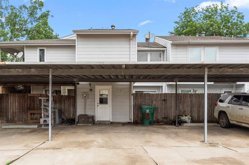 Charming two-story townhouse with a fenced patio area. Features a covered carport for convenient parking and additional outdoor storage space. Ideal for comfortable, low-maintenance living.