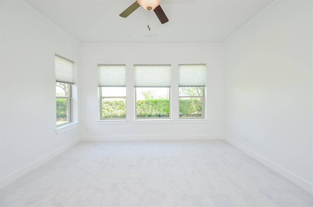 Downstairs Primary Bedroom with Added Extra Window for Natural Lighting and Added Backyard Access Door.