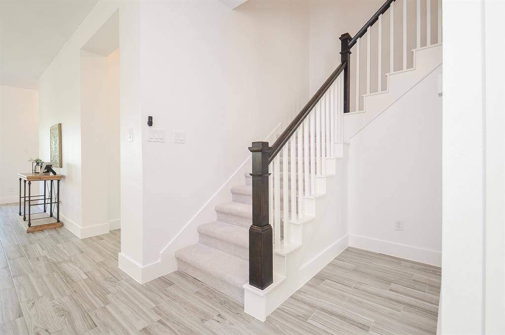Stairway at Entry Hall Leading to Kitchen and Great Room