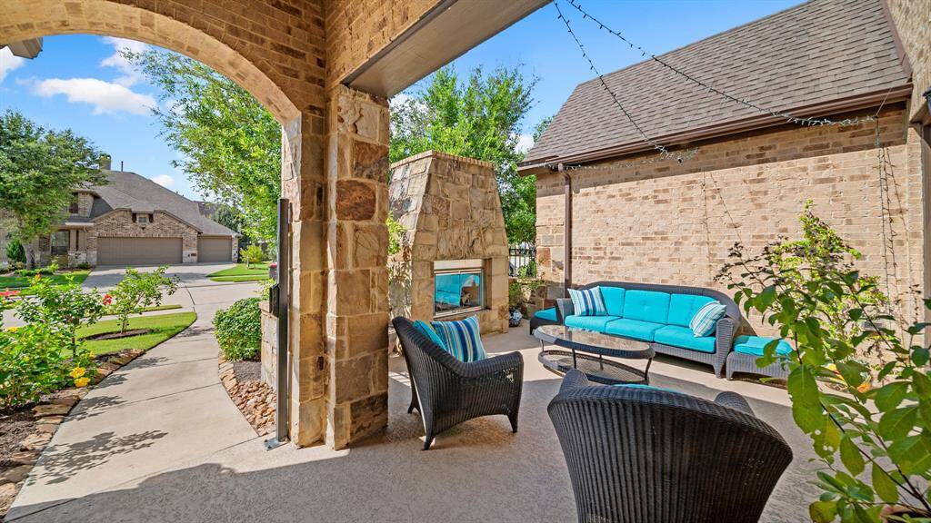 The Front Courtyard with Fireplace has Wrought Iron Fencing and Private Secure Locking Gate~ Fabulous Space for Gatherings with Friends and Family