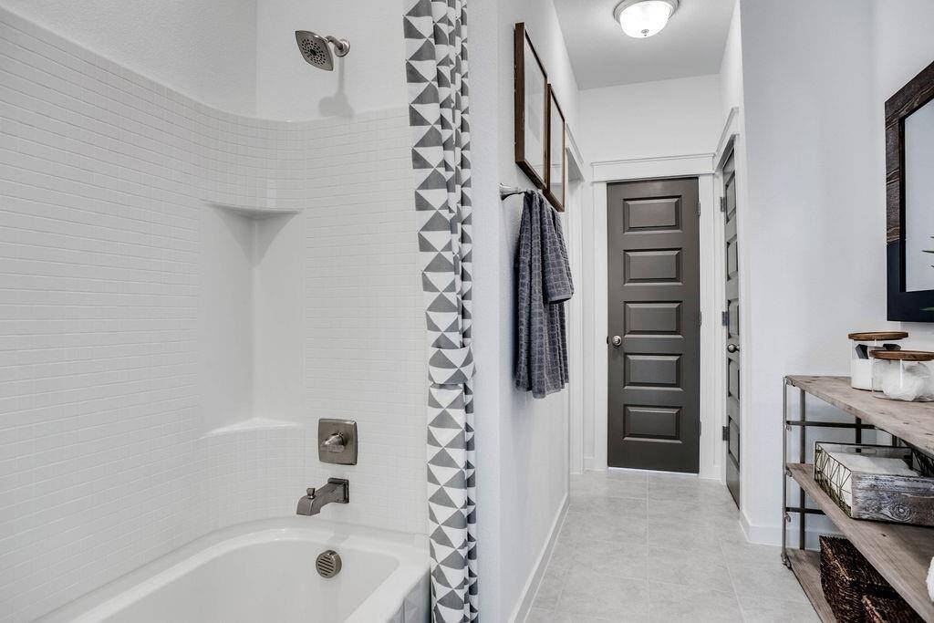 Representative photo of the Cypress plan Secondary Bathroom. Shown to highlight that each bathroom is a testament to thoughtful construction, featuring sleek fixtures that not only look fabulous but also make your family's daily routine a little more enjoyable.