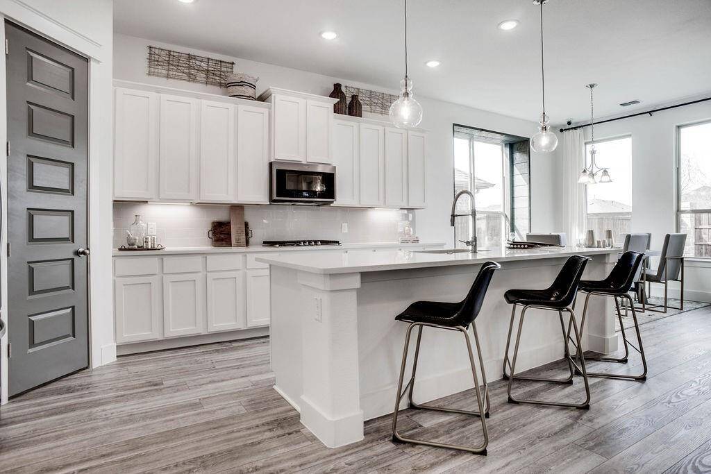 Representative photo of the Cypress plan Kitchen. Shown to highlight Every detail has been thoughtfully designed, from the state-of-the-art appliances that make meal prep a breeze, to the charming backsplash that adds a touch of personality.