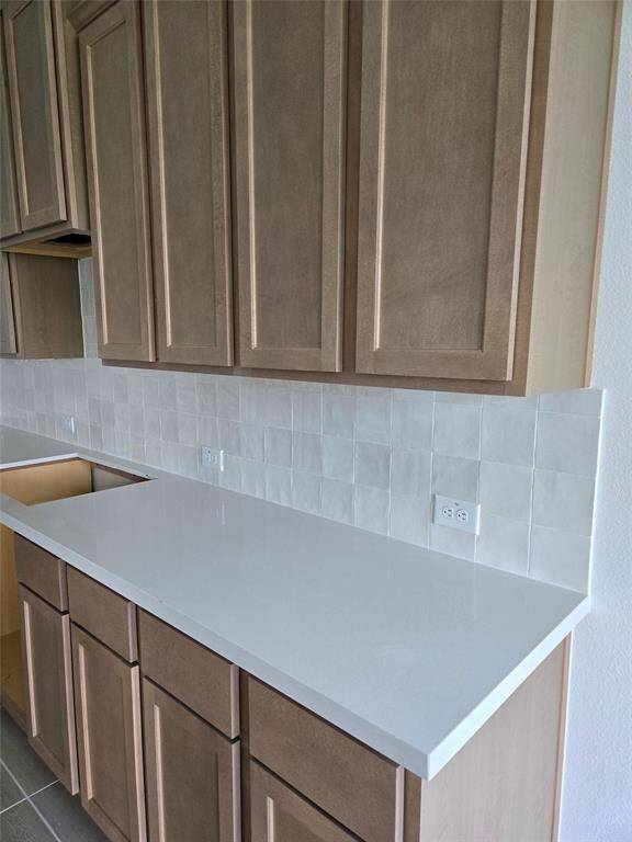 Progress photo of the Cypress at 8235 Red Shiner Way to show Cabinet, Backsplash and Countertop colors. Home is under construction.