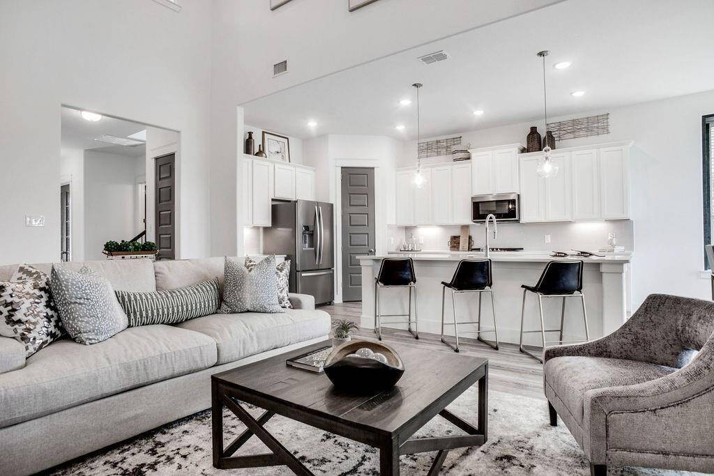Representative photo of the Cypress plan Living Room. Shown to highlight the spacious layout and seamless connection to the kitchen and dining areas