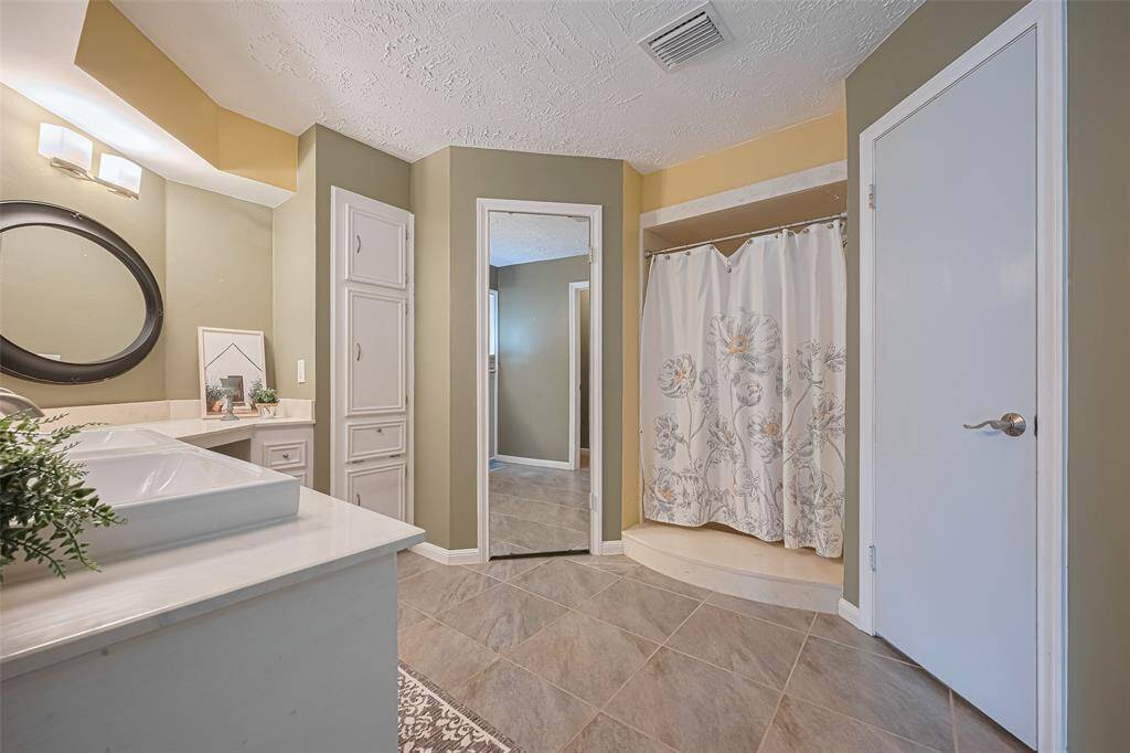 Primary bedroom features plenty of cabinet space, two walk-in closets and a spacious shower.