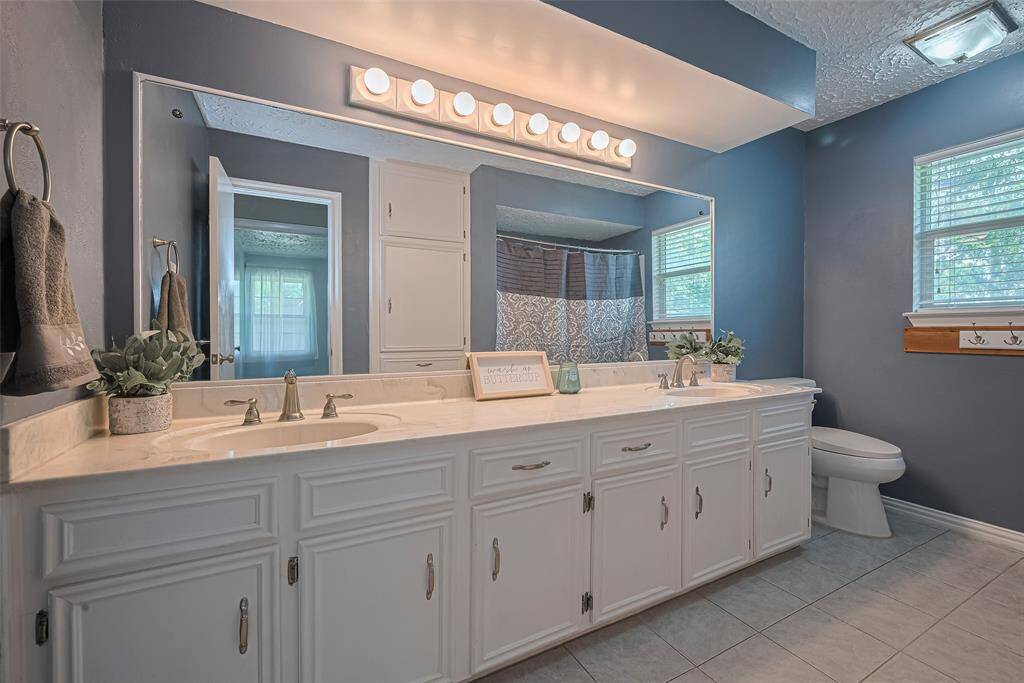 Second bathroom upstairs features dual sinks and recently updated shower & tub.