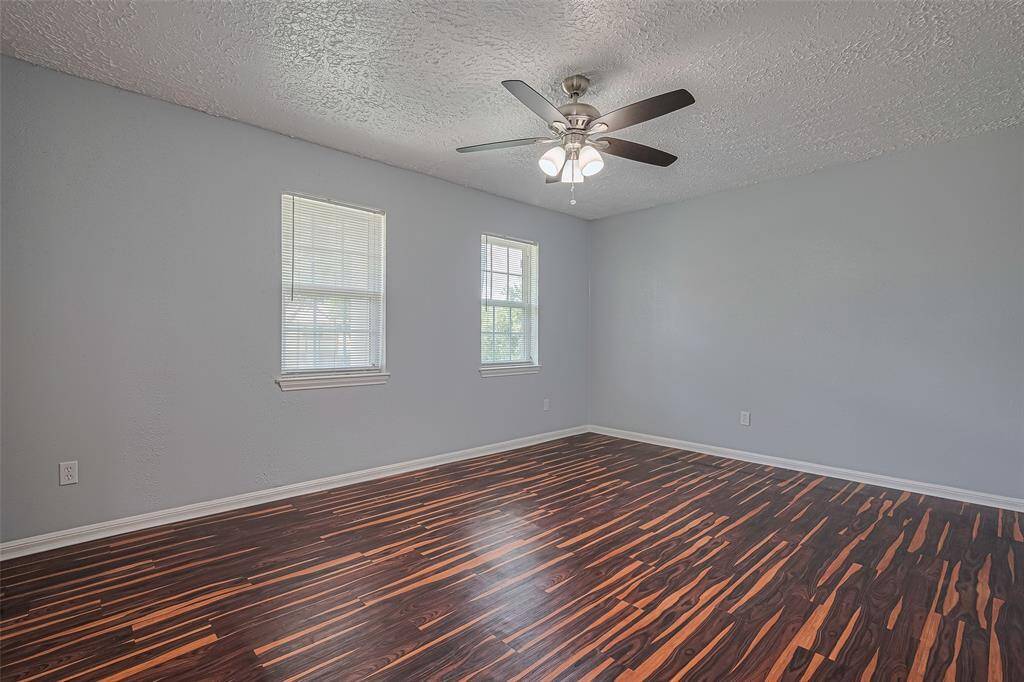Bedroom #3 upstairs features laminate flooring and a very large walk-in closet with windows.