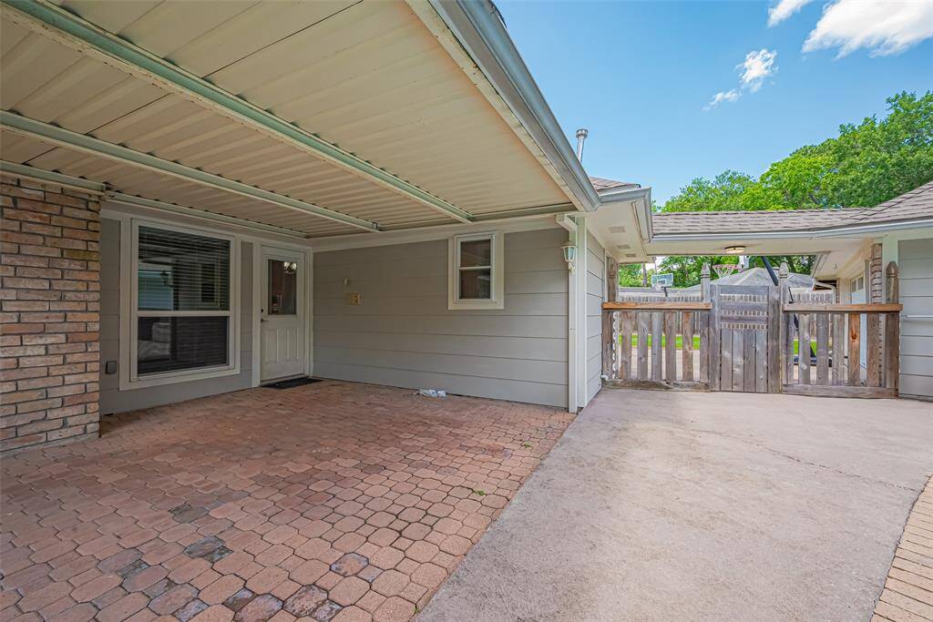 Covered patio and gate to the backyard