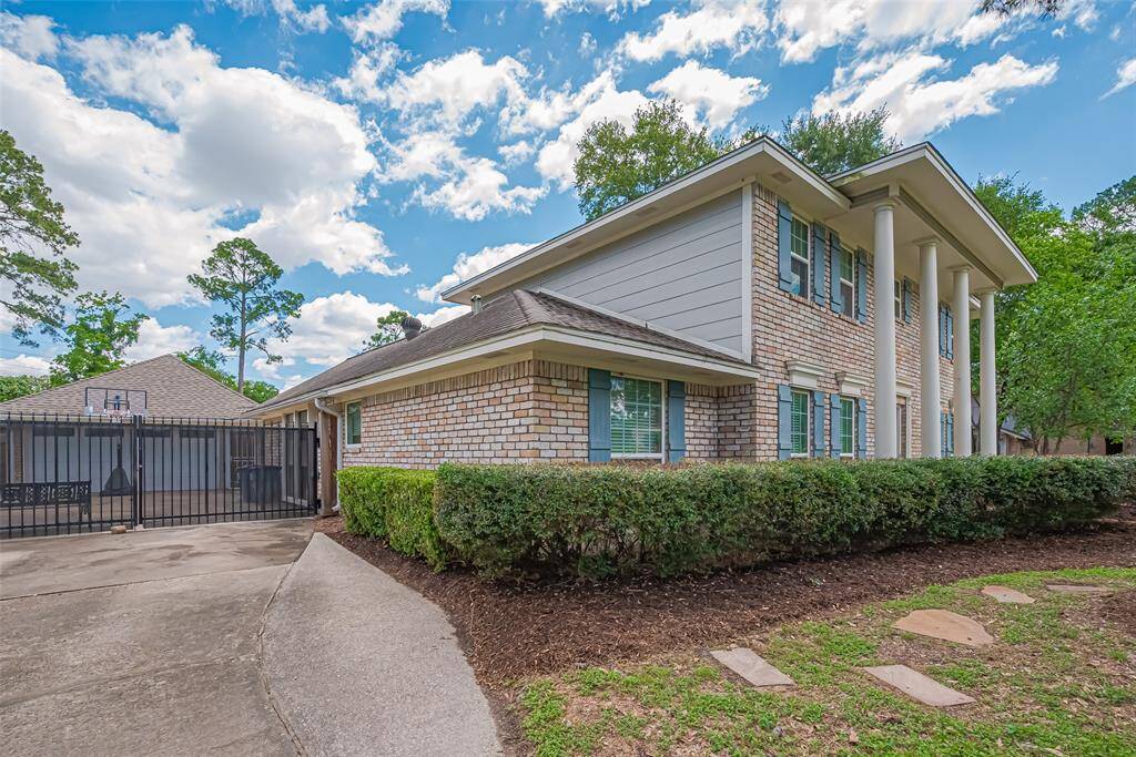 A long driveway and a gate entry for the garage.  Plenty of room for parking cars.