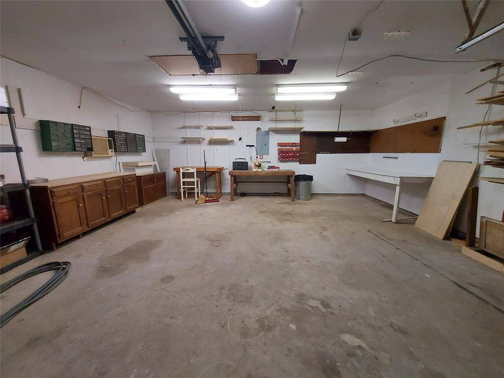 The garage offers plenty of room to park two vehicles and a workshop area and storage space.