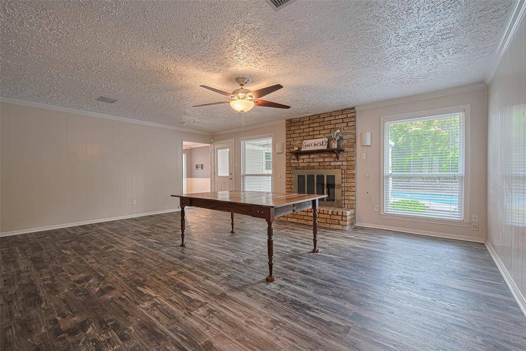 Den area is spacious and features a cozy fireplace.