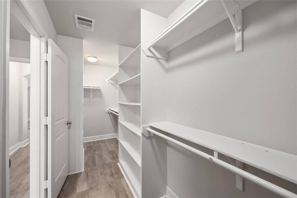 Primary closet offers tons of space and organization!