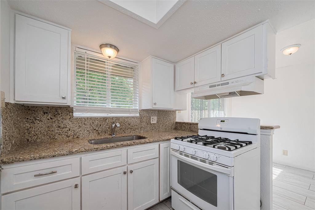 Kitchen with ample cabinet space and a gas cooktop.