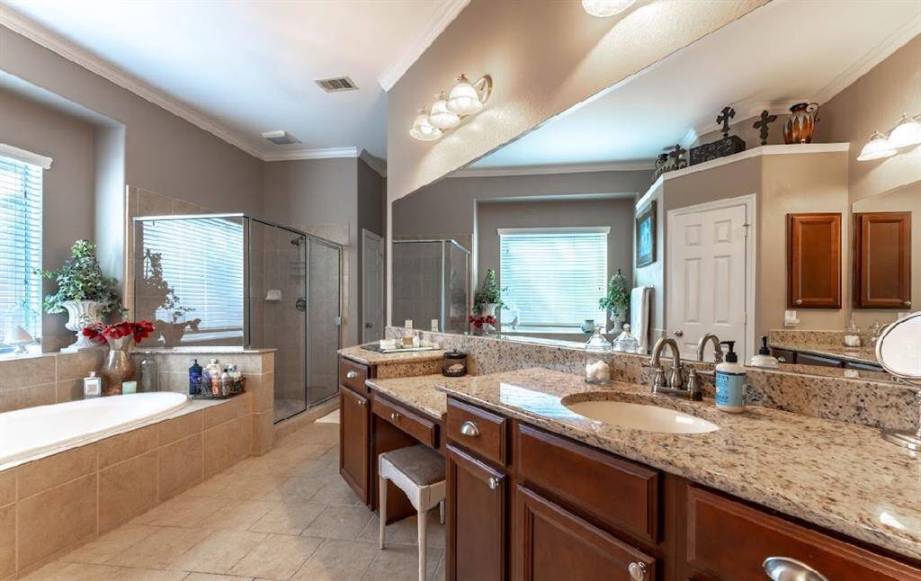 The primary bathroom has a separate tub and shower and ample vanity space.