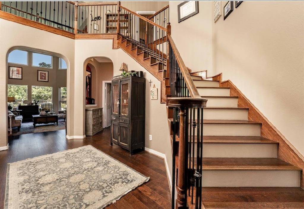 Upon entering you're greeted with beautiful luxury wood floors and a grand staircase.
