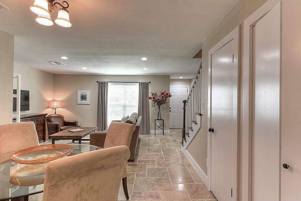 This open concept floor plan boasts plenty of storage space! Note the travertine floors throughout the downstairs.