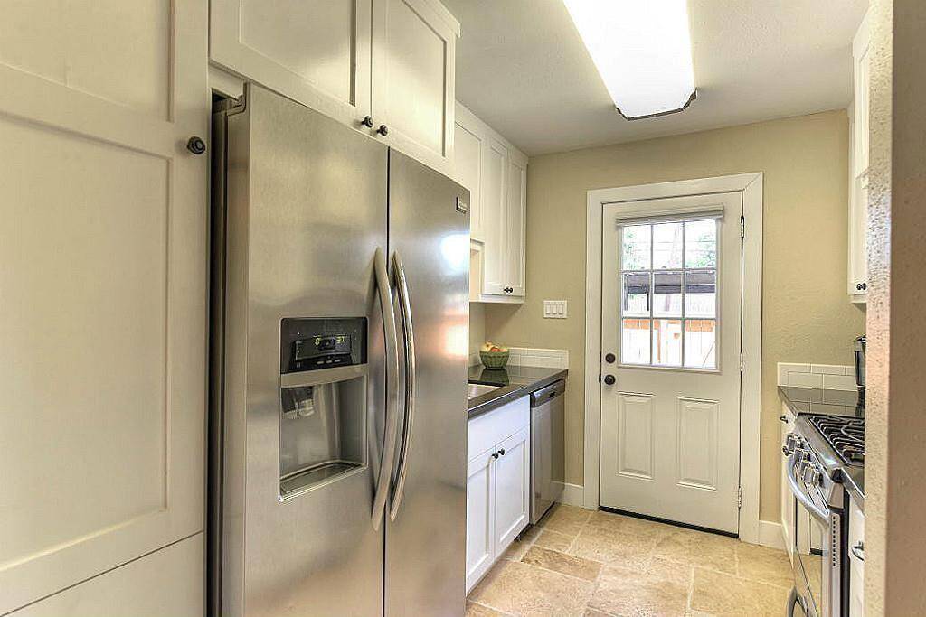Your high-end kitchen features stainless steel appliances, a gas range, and stone countertops.
