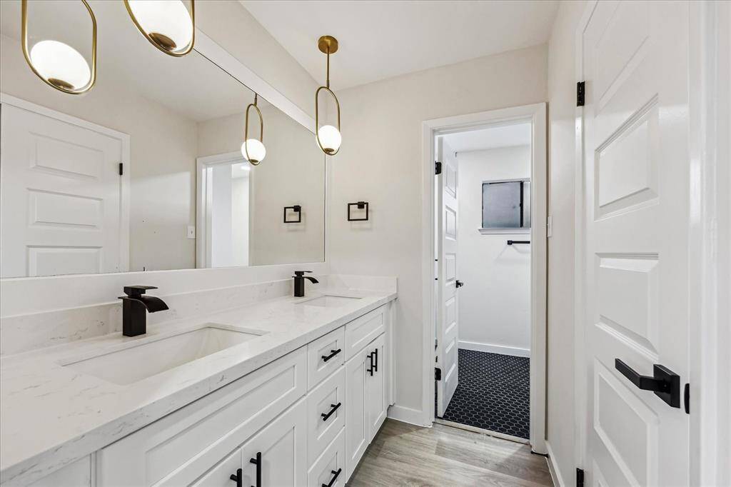 Double Sink Vanity with storage drawers and contemporary pendant lighting