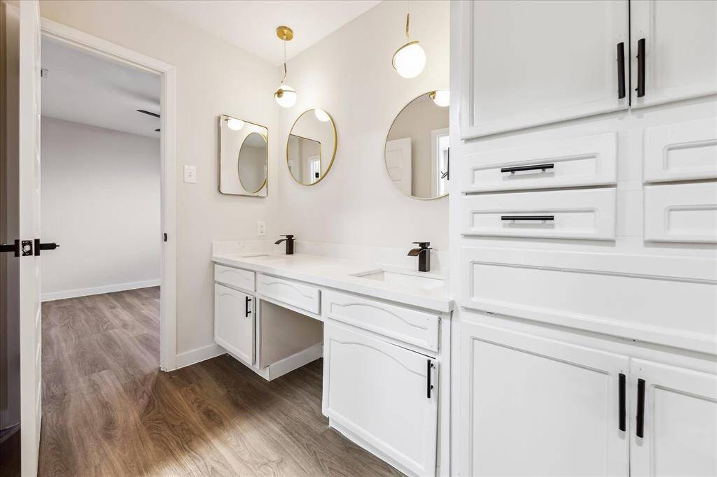 Double Sink vanity w/ storage drawers & contemporary pendant lighting