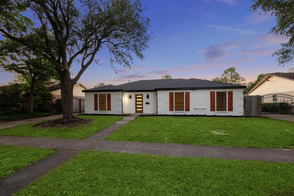 Modern curb appeal with fresh white brick & rich wood accents