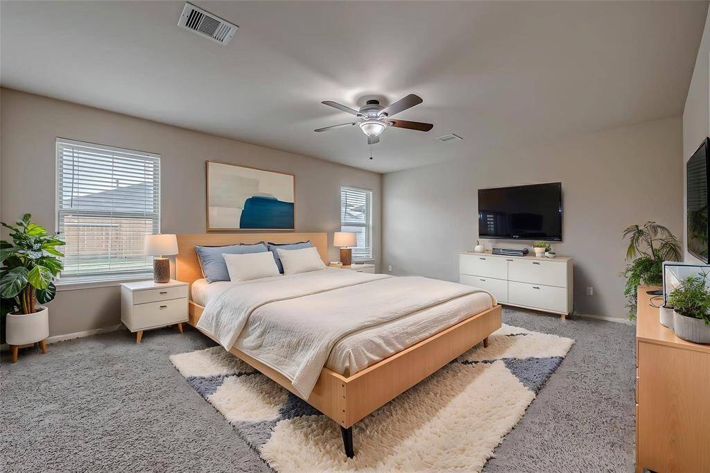 The virtually staged primary bedroom is designed to highlight its spacious layout and serene atmosphere, creating an inviting retreat. The design showcases the room's potential for comfort and relaxation, with carefully selected furnishings that enhance its cozy and stylish appeal.