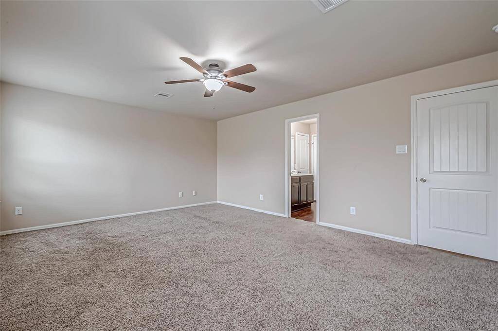 The ensuite primary bedroom serves as a private retreat, offering a spacious layout and luxurious features. Its attached bathroom provides a serene space for relaxation, enhancing both the comfort and convenience of this peaceful sanctuary.