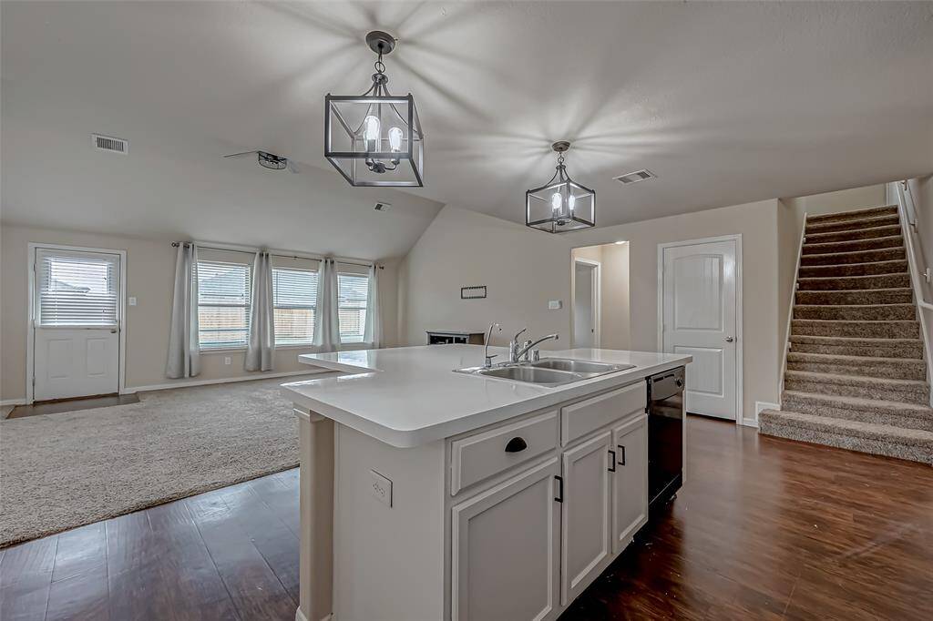 The kitchen opens seamlessly to the family room, creating a natural flow that’s perfect for everyday living and entertaining. This open-concept layout encourages connection, allowing you to cook while staying engaged with family or guests. It enhances the sense of space and fosters a warm, welcoming atmosphere throughout.