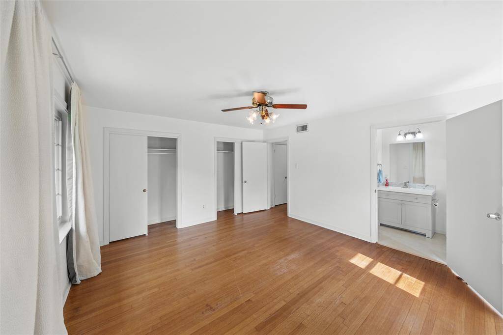 Front bedroom with closets and half bath.  A large room with loads of natural light.