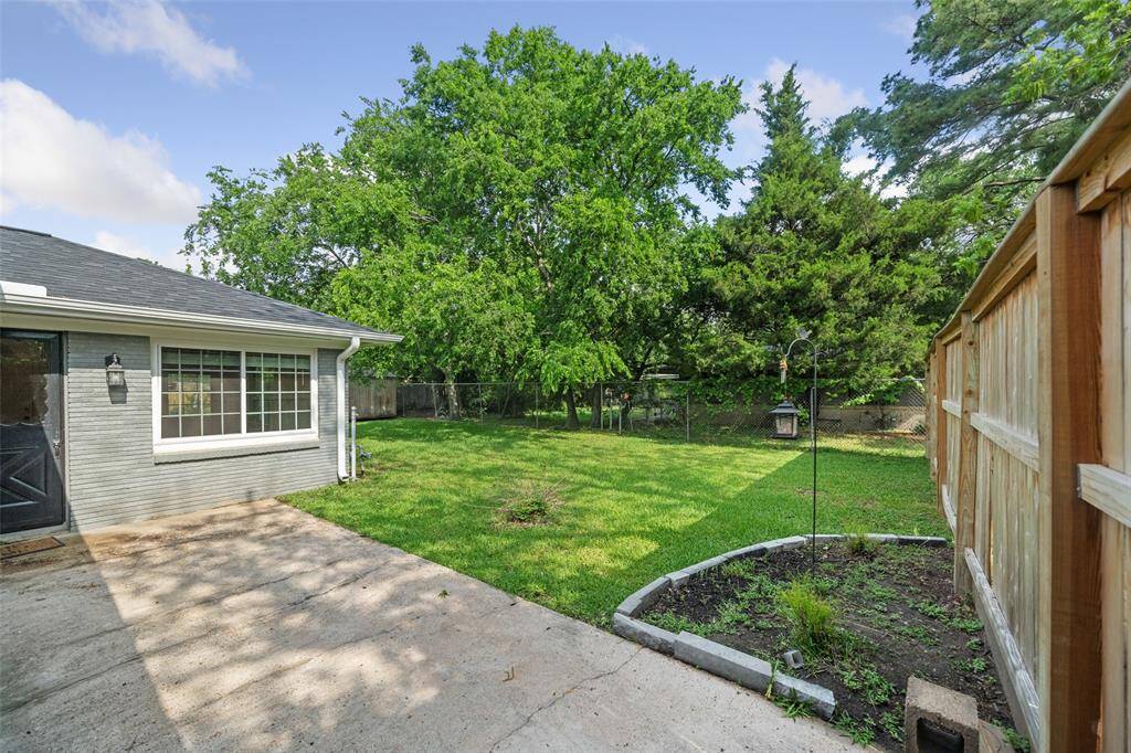 View from side of the house into the back yard.  Lots of room to expand or for the kids to play.