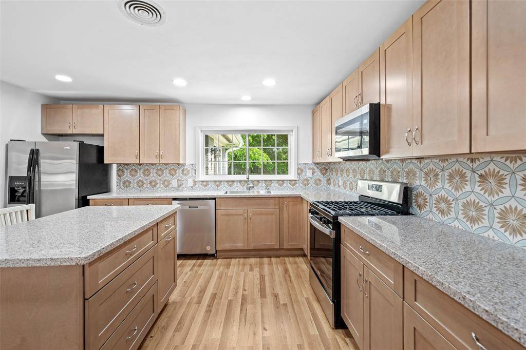 Another view of the kitchen.  Large wide areas give you plenty of space to work and visit with others.  Large island provides even more counter space to an already ample amount.